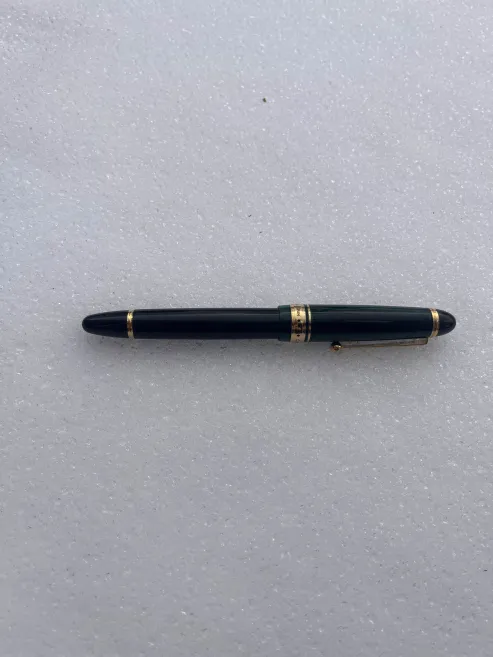 The pen resting gently on snow